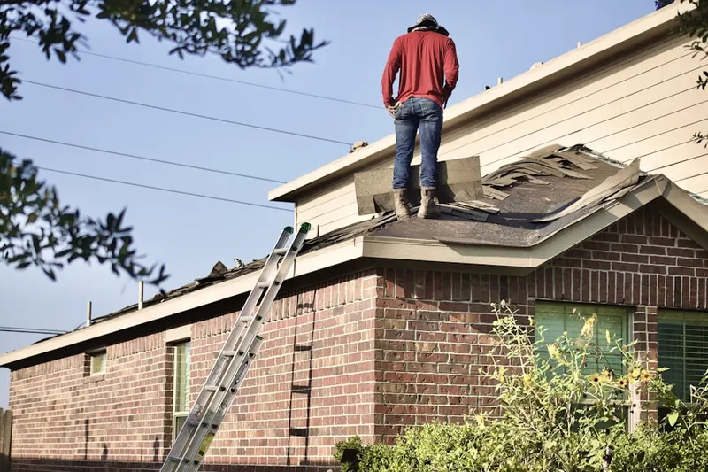 Professional roofer working on a residential roof in New Franklin
